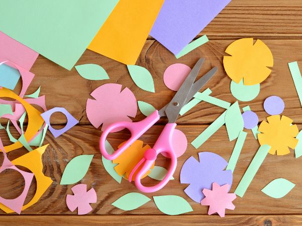 paper and siccors with paper flowers cut out