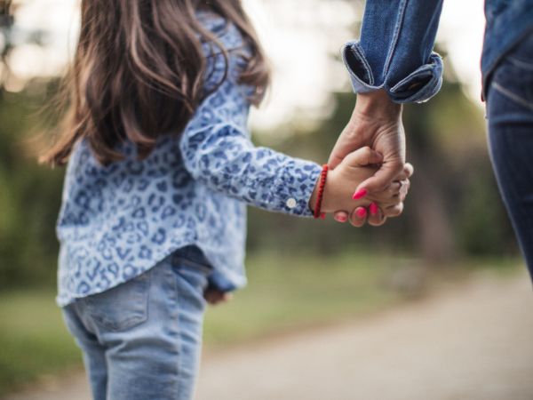 Parent holding a child's hand