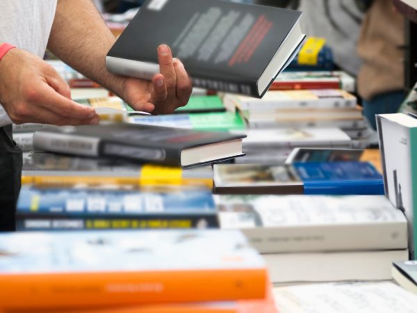 close up of hands looking at books