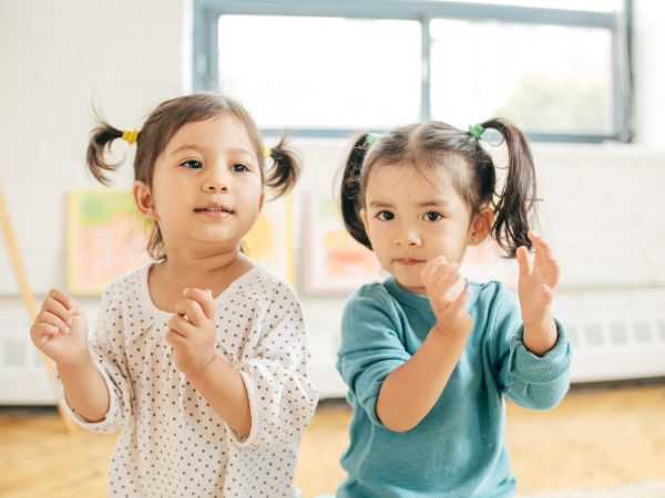 two toddlers clapping